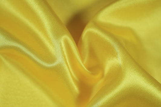 Leuchtender gelber Satin Stoff für Dekoration & Mode
